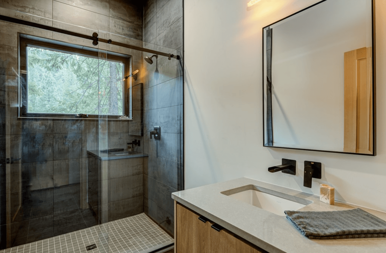 Newly constructed bathroom with large, tiled shower and sink