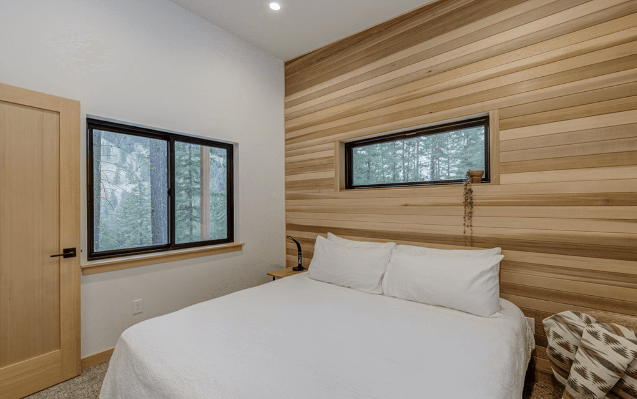 Newly constructed bedroom with cedar paneling on one wall