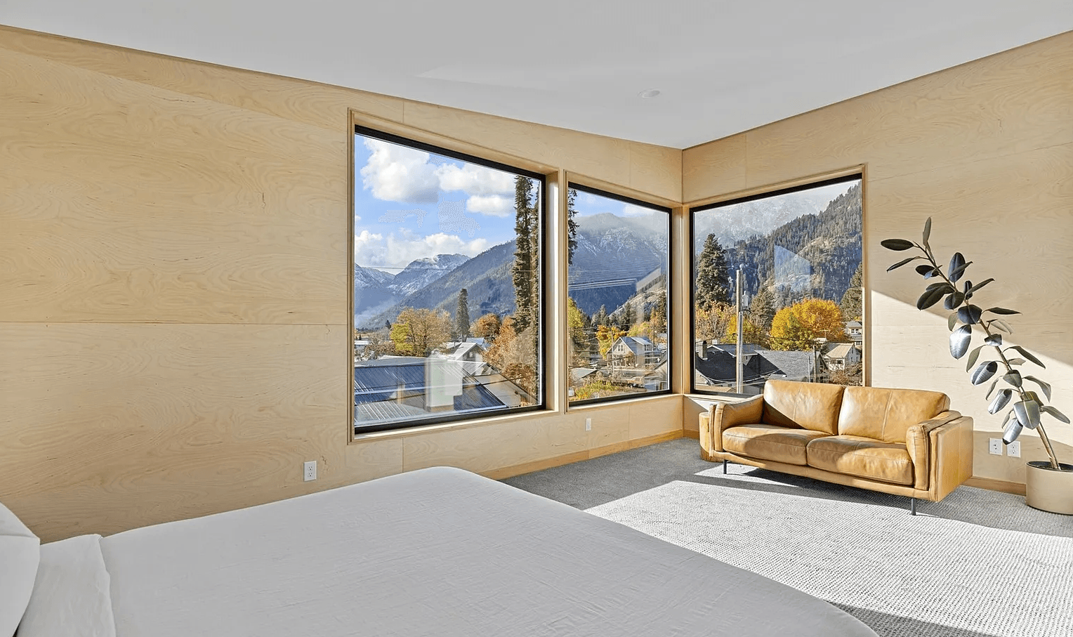 View from the bed of modern, newly constructed master bedroom with mountain views