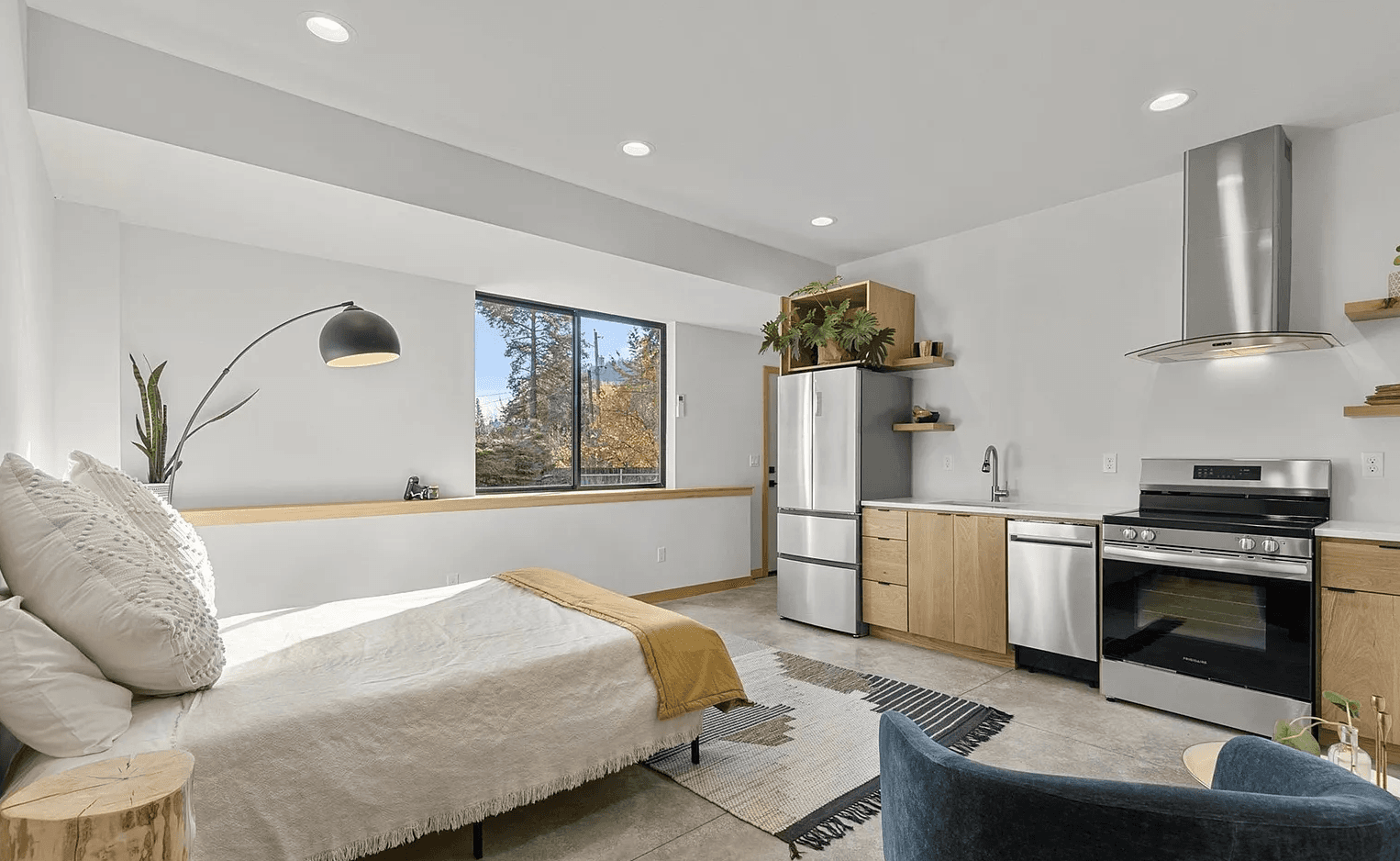 Interior of modern accessory-dwelling-unit studio showing bed and kitchen area