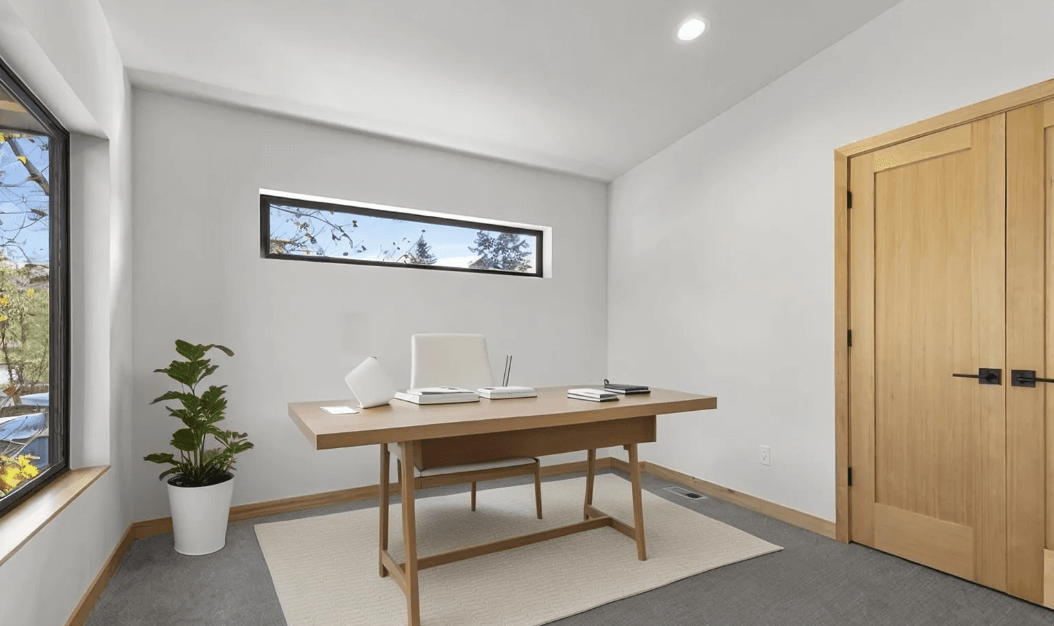 Interior of modern, newly constructed home office with desk, chair and closet