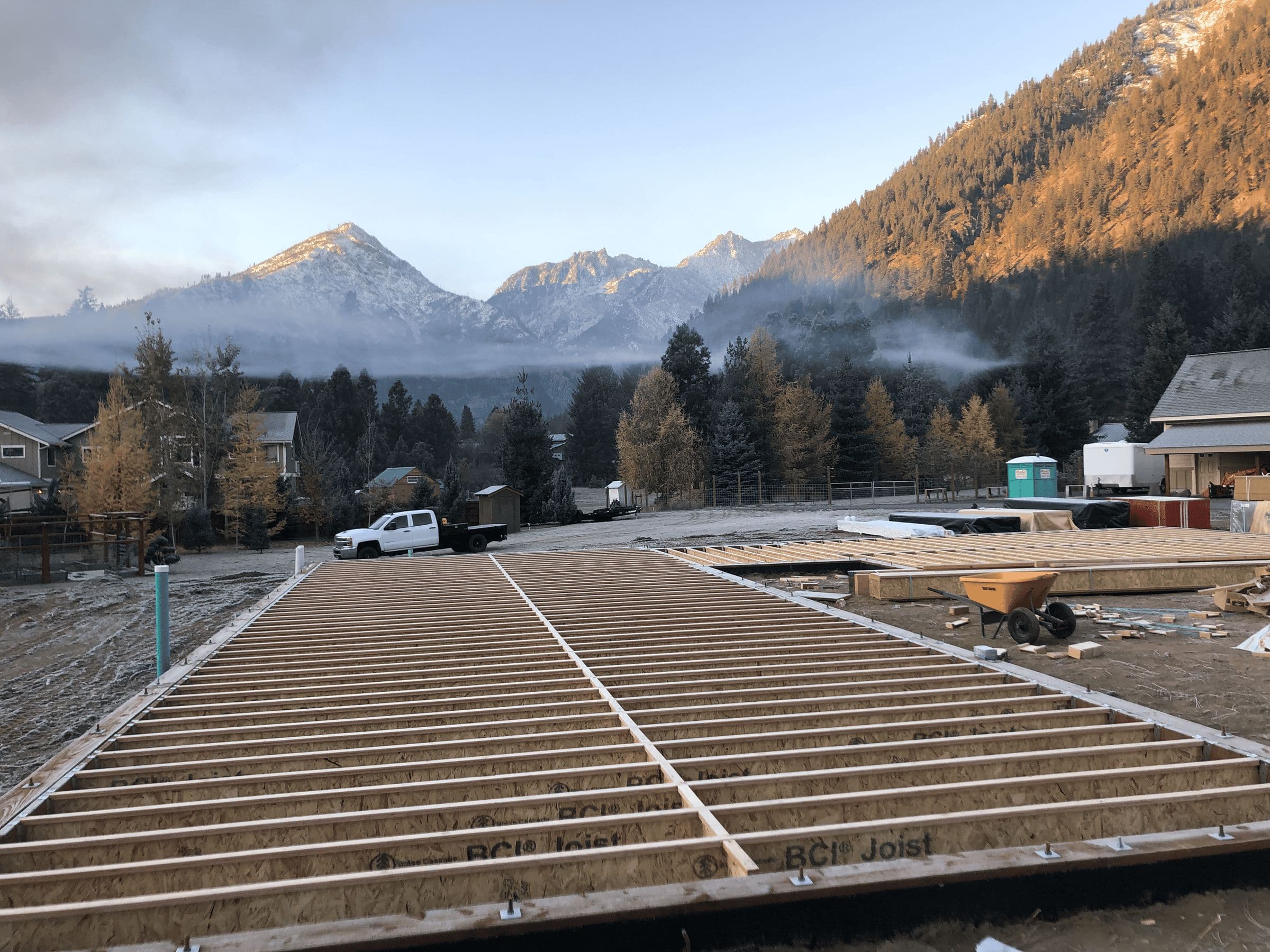 Joists for sub-floor construction of a residential home with mountains in the background