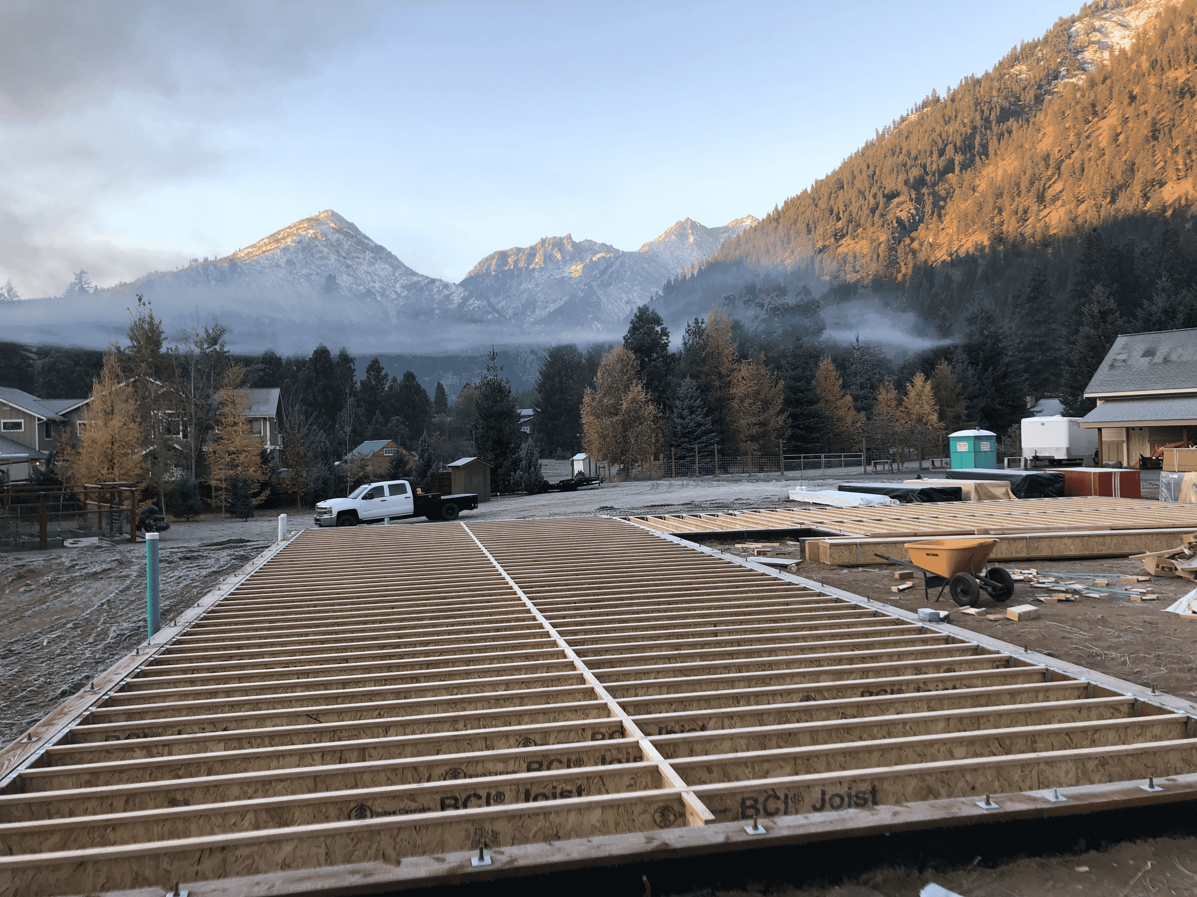 Joists for sub-floor construction of a residential home with mountains in the background