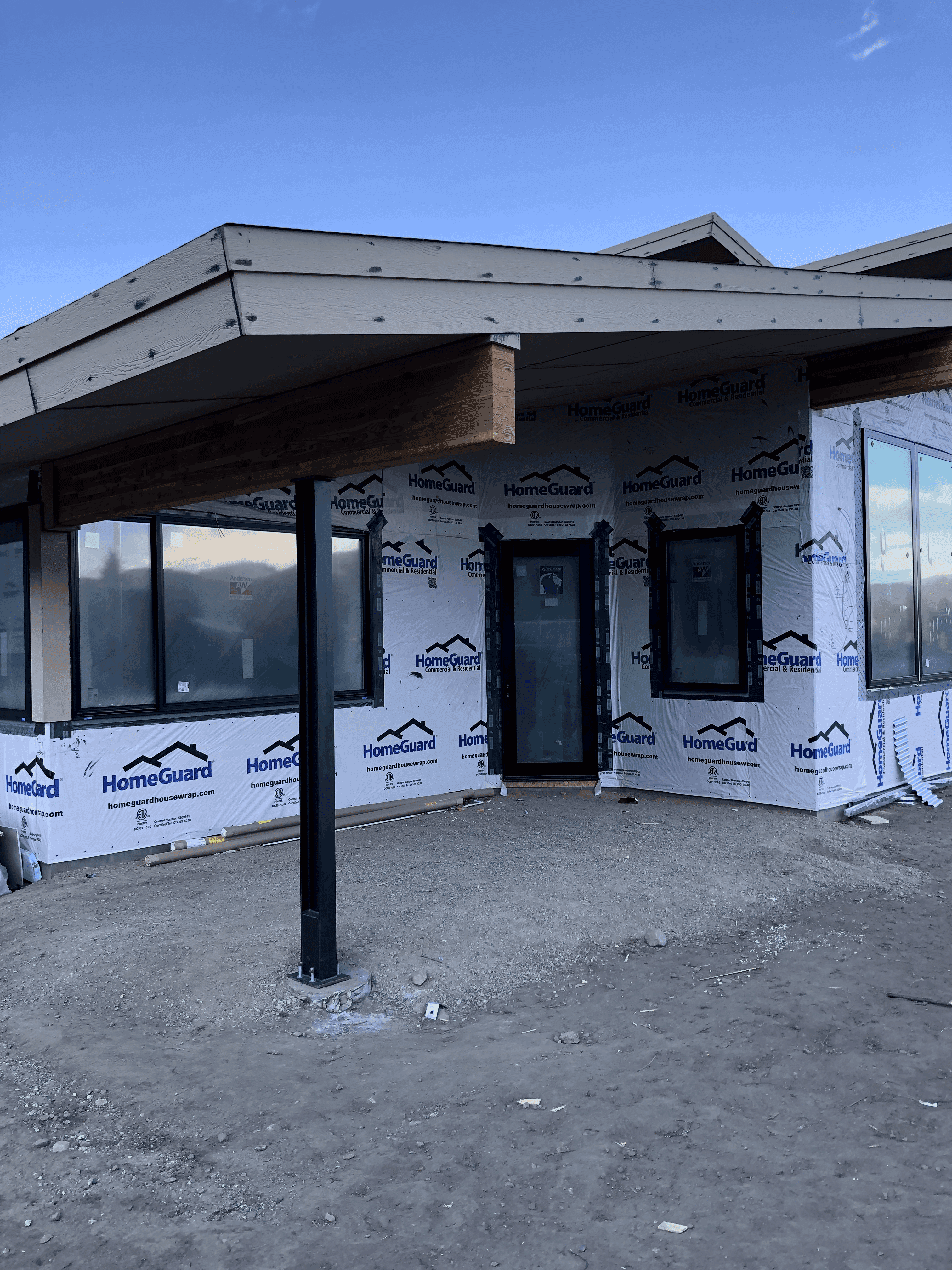 Close up of exterior of covered, modern entryway of home under construction