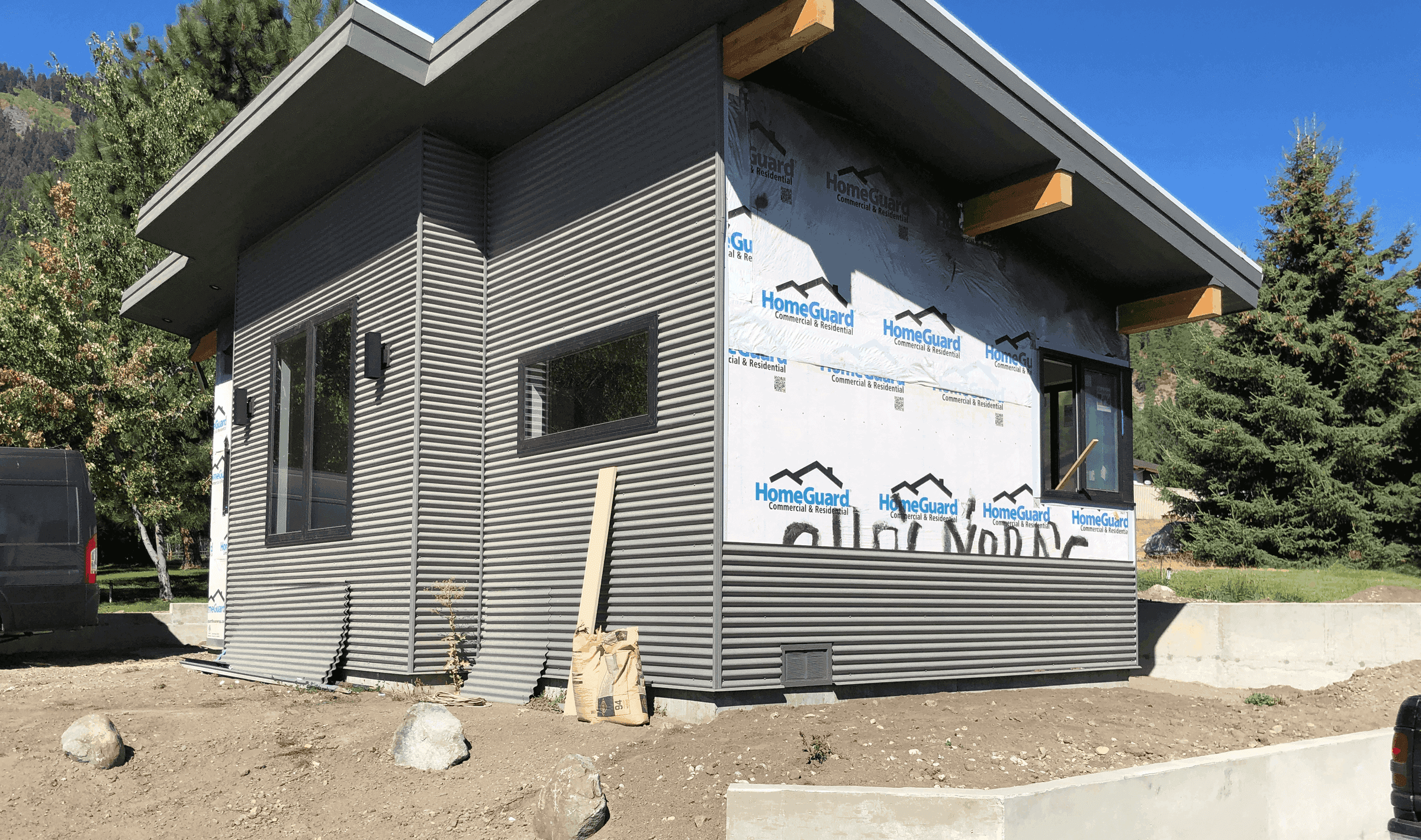 Angled profile of modern one story detached under construction during the siding process