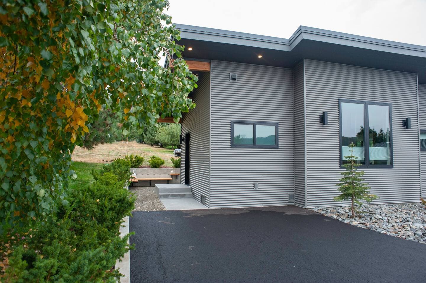 Exterior of modern detached accessory dwelling unit with metal siding and wooden accents