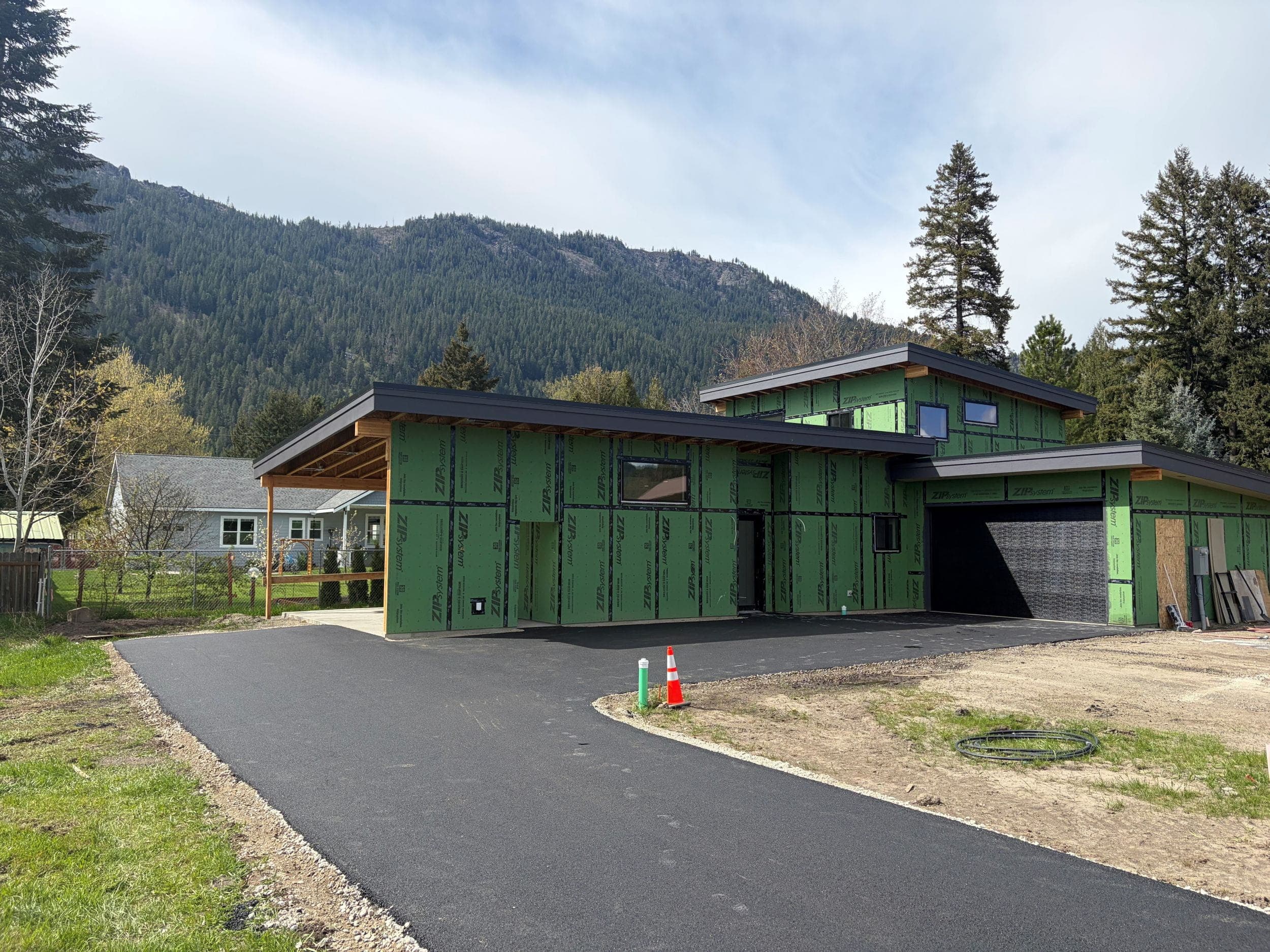 Exterior of Orchard Street house with mountains in background, prior to siding being applied.